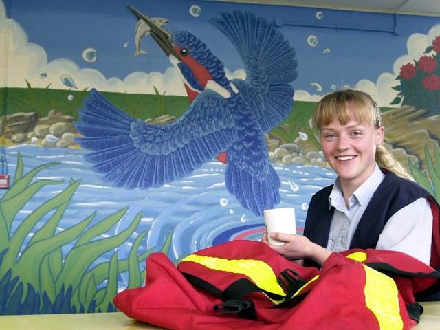 Postie Charlotte Green enjoy a brew by the mural she painted in the canteen at Hunslet Delivery Office.