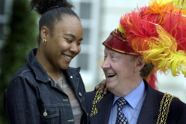 The Lord Mayor of Leeds, Coun Bernard Atha, tries Leeds West Indian Carnival Queen Sarai Campbell's head dress for size.