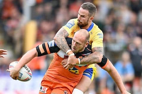 Liam Watts is tackled by Ben Crooks during Tigers' win over Hull KR. Picture by Will Palmer/SWpix.com.