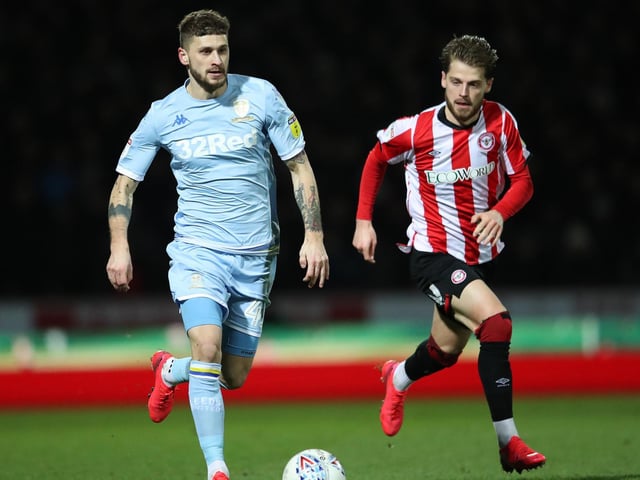 Mateusz Klich drives forward as Brentford's Mathias Jensen chases.
