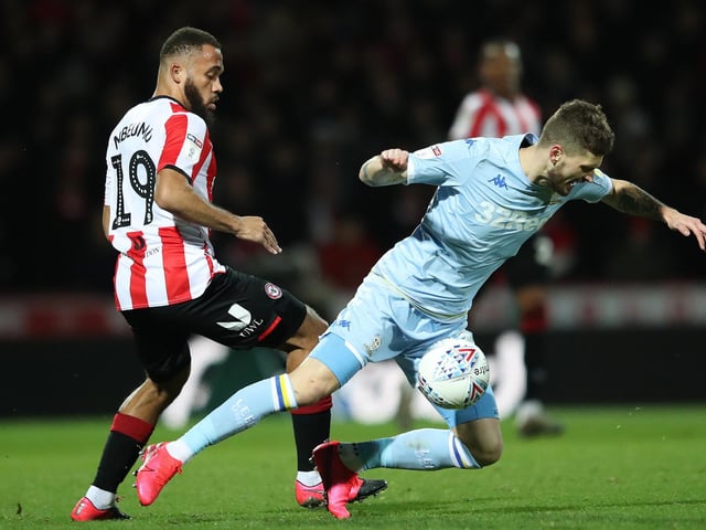 Ben White is challenged by Brentford's Bryan Mbeumo.