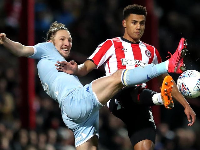 Luke Ayling reaches out for the ball ahead of Brentford's Oli Watkins.