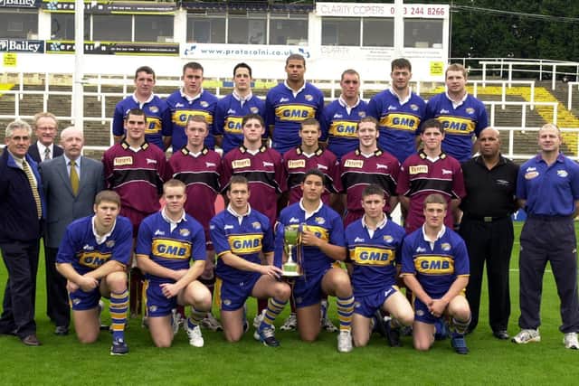 Rhinos' 2001 academy squad with the Grand Final trophy. Picture by Tony Johnson.