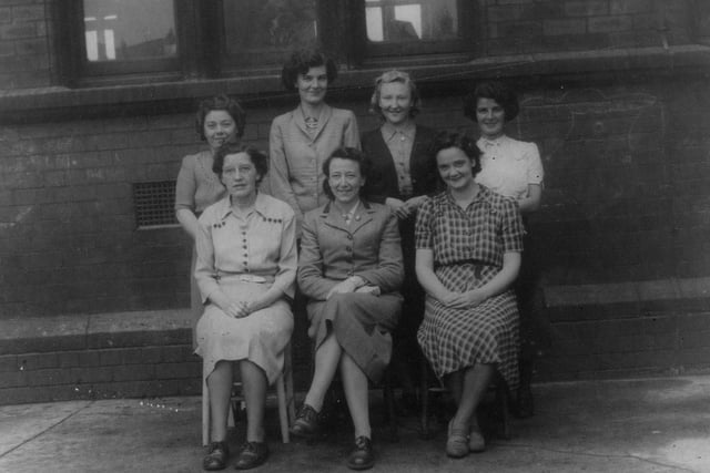 A group of staff photographed outside the school. Year unknown.