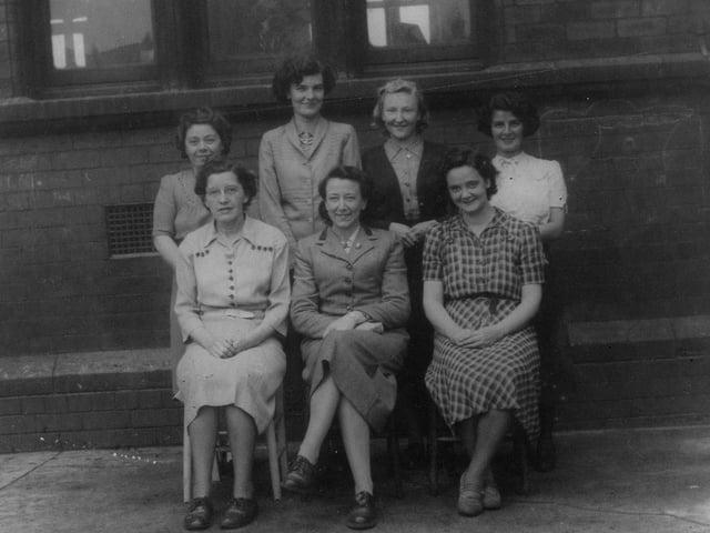 A group of staff photographed outside the school. Year unknown.