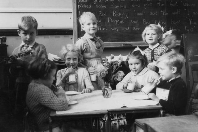 A group of children during their milk break. The Free School Milk Act of 1945 stipulated a quota of a third of a pint of milk a day for every child under the age of 18 years. From 1971 this changed to under seven years only,