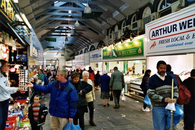 Shoppers make their way down a row of fish stalls in October 1999.