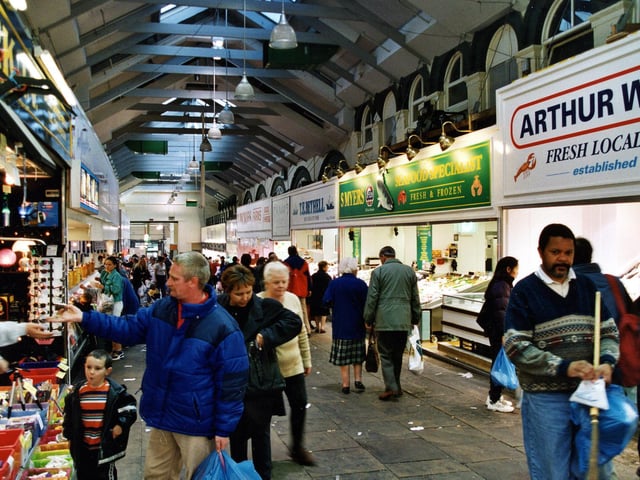 Shoppers make their way down a row of fish stalls in October 1999.