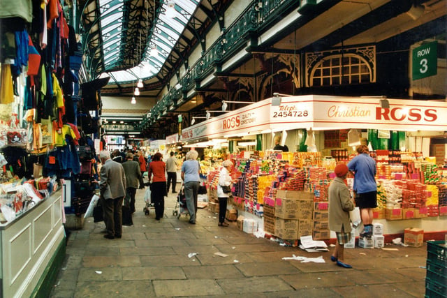 There is a Children's Clothes stall on the left with Christian Ross Confectioners on the right pictured in September 1999.