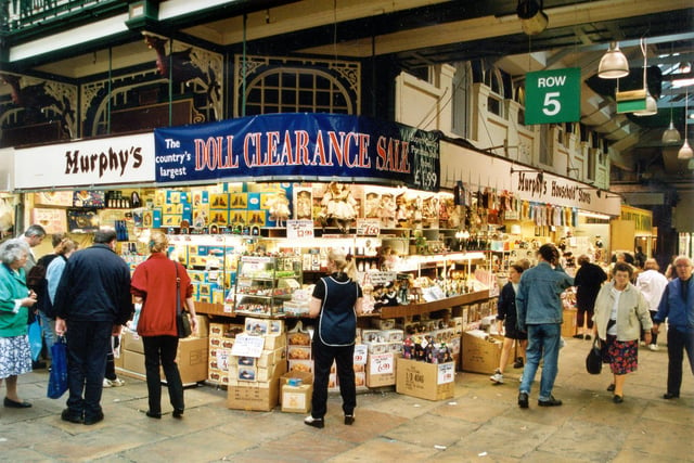 Row 5 of Kirkgate Market Hall interior, showing shoppers and Murphy's Household store on the corner.