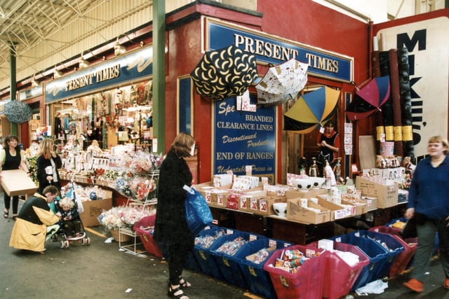 Discount shop The Present Times pictured in October 1999. To the left, a stall worker carries a box to the display at the front of the shop.