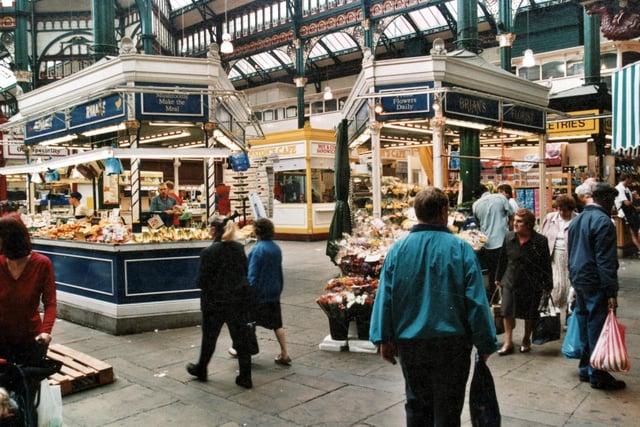 Shoppers around the stalls of Ryan's Fruit and Vegetables and Brian's Florists in September 1999.