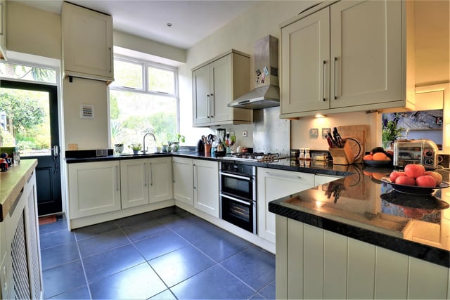 The kitchen with diner 'hub' has multiple fitted units with granite worktops, and a door leading out to the garden.