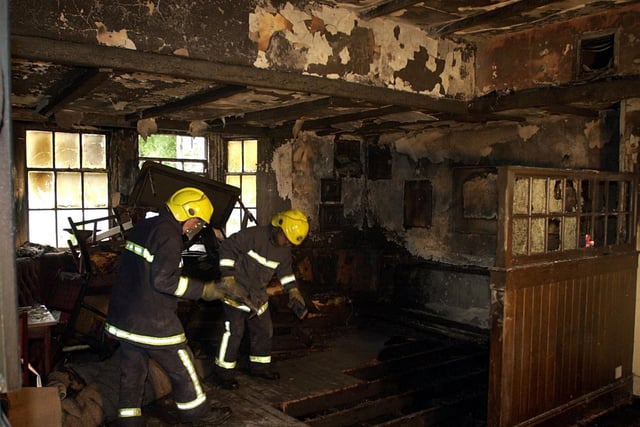 Firefighters dampen down after a blaze ripped through The Dyneley Arms.