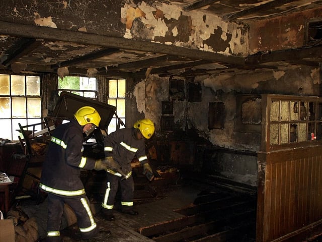 Firefighters dampen down after a blaze ripped through The Dyneley Arms.