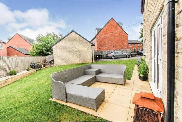 Enclosed gardens surround the property with open views to the front.