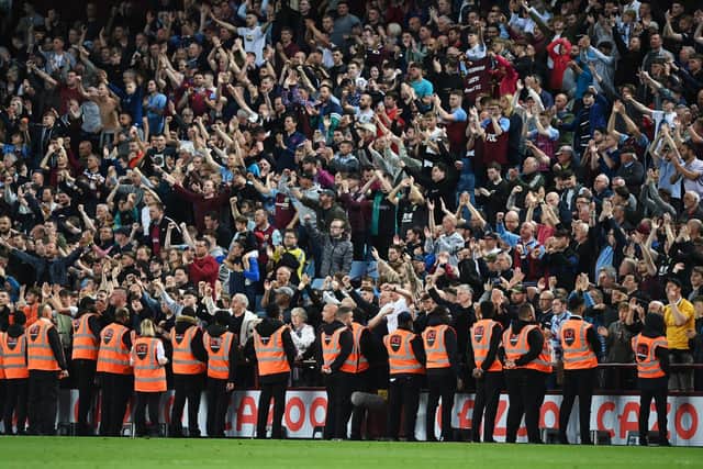 MASSIVE POINT: Burnley's travelling fans celebrate Thursday night's 1-1 draw at Aston Villa. Photo by Shaun Botterill/Getty Images.