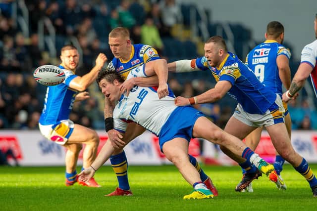Tom Lineham is tackled by Mikolaj Oledzki and Cameron Smith. Picture by Bruce Rollinson.