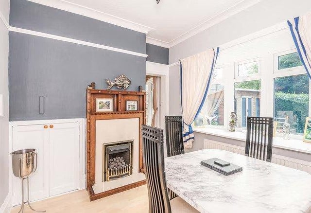 The dining room, fit with a traditional fire place, is perfect for entertaining dinner guests.