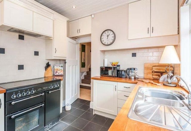 The kitchen is fitted with all modern appliances while keeping that traditional feel.