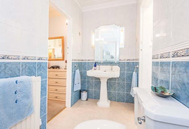 The master bedroom also features a unique open plan en-suite bathroom.