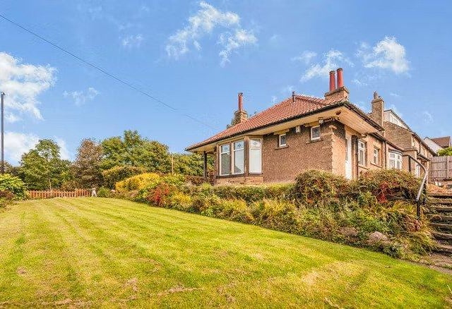 The beautifully presented corner plot boasts deceptively large gardens to three sides with grape vines.