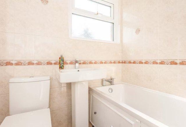 The main bathroom features a bath but no shower.