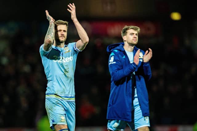 BACK ON TRACK: Whites captain Liam Cooper, left, and striker Patrick Bamford, right, applaud Leeds United's travelling fans after the momentum-shifting 1-1 draw at Brentford of February 2020. Picture by Bruce Rollinson.