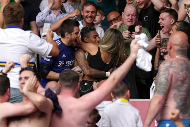 Leeds United man-of-the-match contender Raphinha celebrates survival in the stands with the friends and fans after the Premier League win at The Brentford Community Stadium. Picture: John Walton/PA Wire.