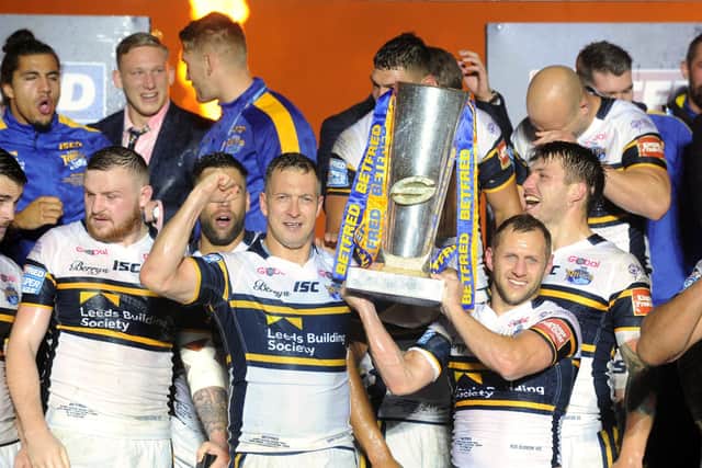 Danny McGuire and Rob Burrow lift the Super League trophy in 2017. Picture by Bruce Rollinson.