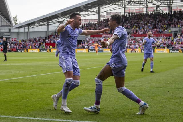 JOB DONE: Jack Harrison, left, celebrates his 94th-minute winner at Brentford and Leeds United's Premier League survival with winger team mate Raphinha, right, whose spot kick put the Whites in front. Picture by Tony Johnson.