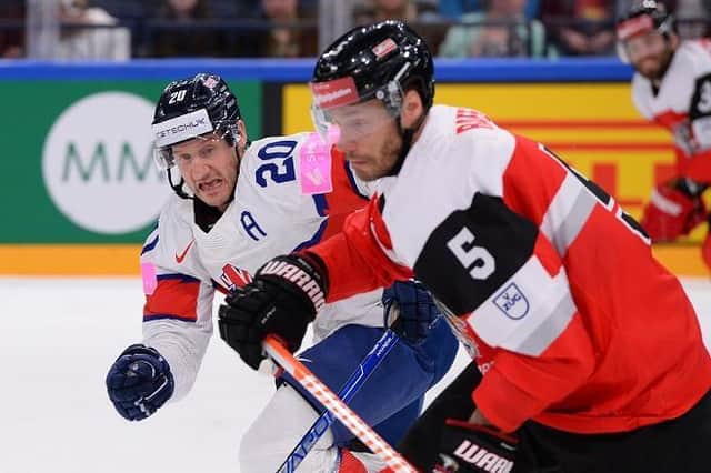 TOUGH NIGHT: Jonathan Phillips battles with Austria's Thomas Raffl in the Group B relegation decider in Tamper, Finland. Picture: Dean Woolley/IHUK.
