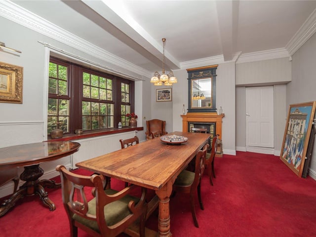 Here there is space for a large dining table and chairs, with a fireplace and sizeable windows adding to the room's character.