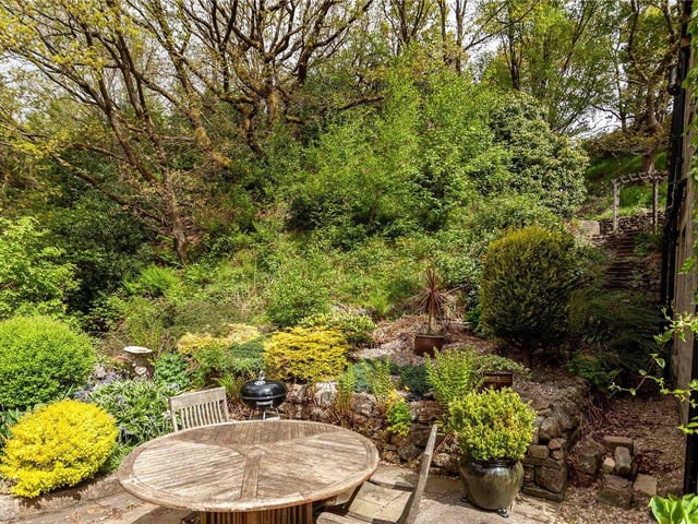 An area in which to dine al fresco within the tiered rear garden.
