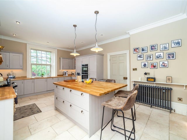 The breakfast kitchen is light and spacious, with windows at each end. It features an island unit, and an Aga stove.