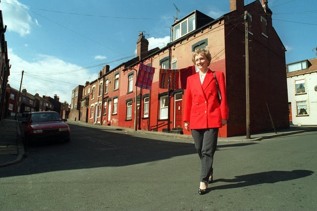 A smilingJune Hancock walks through the streets of Armley close to the former J.W.Roberts asbestos factory after receiving news of her court victory in April 1996 .