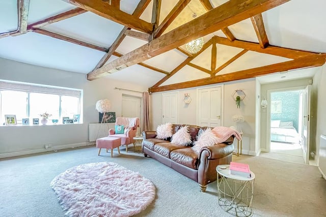 Versatile rooms include this one with open vaults and beams.