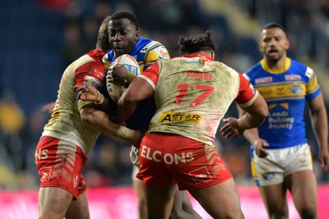 Leeds Rhinos' Muizz Mustapha is held by St Helens' Louie McCarthy-Scarsbrook and Agnatius Paasi.
 Picture: Bruce Rollinson.