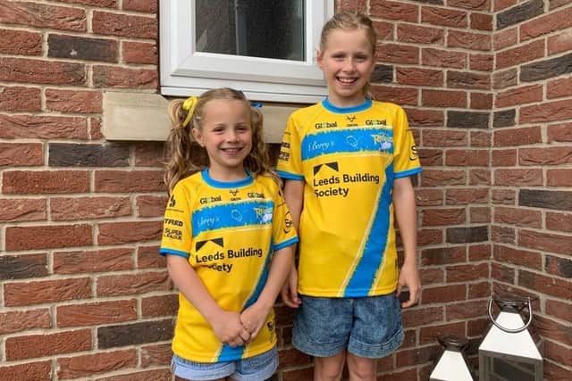 Rob Burrow's daughters Maya and Macy model the Magic Weekend shirt they helped design. Picture by Leeds Rhinos.
