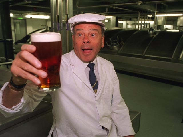 Umpire Dickie Bird eyes up a pint of Tetley's Bitter after opening the Dickie Bird Room at Tetley's Brewery.