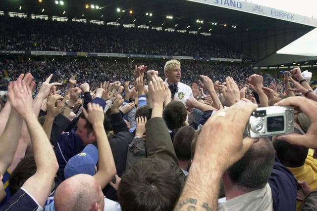 Alan Smith is mobbed by the fans after the match.