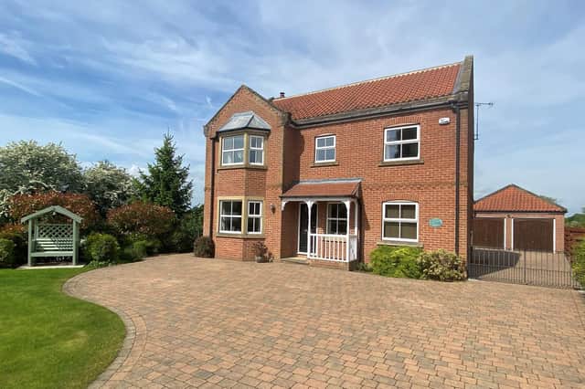 A six bedroom family home is for sale near Leeds. Features include a patio with views of the countryside and landscaped gardens.