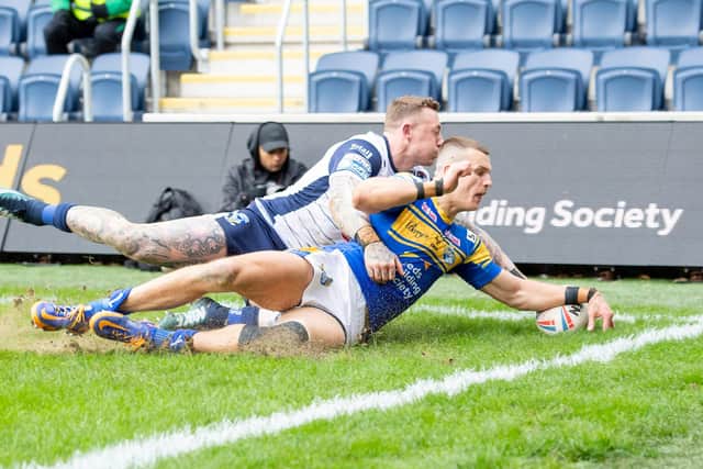 Warrington's Josh Charnley can't prevent Leeds Rhinos' Ash Handley from scoring a try during February's clash between the sides at Headingley. Picture: Allan McKenzie/SWpix.com.