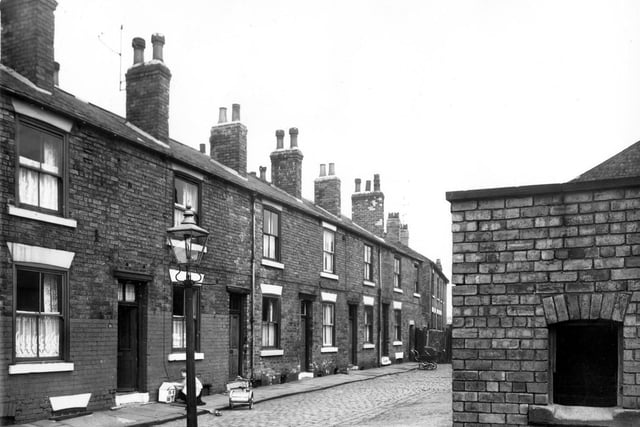 Wainwright Row in April 1959.  These houses are back to backs. In the foreground is a midden once used for storing household waste.