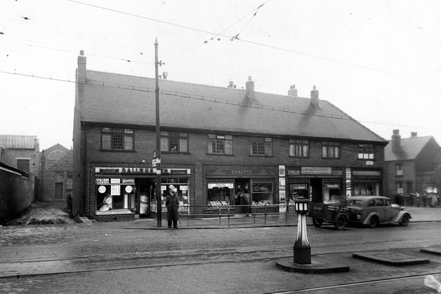 Belle Isle Road in March 1951. Andersons newsagent, E.H. Batty fruit, veg, fish and rabbit seller and Gallons Ltd. grocer are all in view.