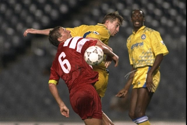 Lee Chapman gets ahead of Stutgart's Guido Buchwald (left) during the European Cup first round replay at the Nou Camp. Leeds won 2-1.