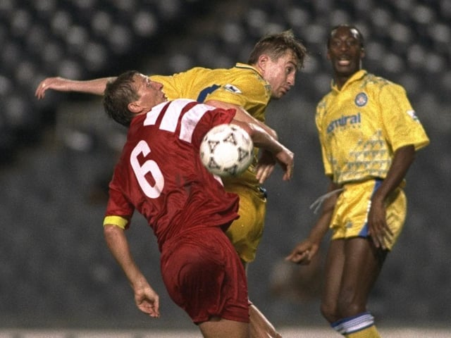 Lee Chapman gets ahead of Stutgart's Guido Buchwald (left) during the European Cup first round replay at the Nou Camp. Leeds won 2-1.