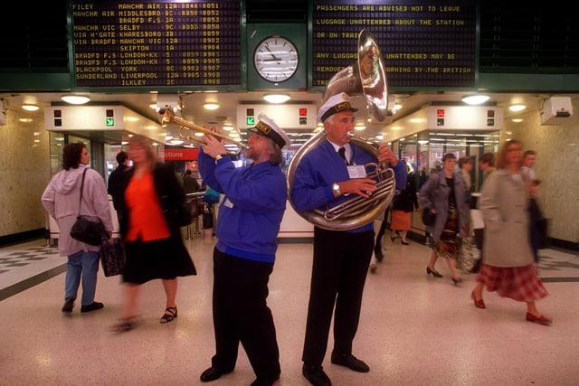 Members of The Phoenix New Orleans Parade Band - John Pashley (left) and Pete Whitehead -  brighten up commuters on their way to work at Leeds City Station as part of the Leeds Summer Heritage Festival.