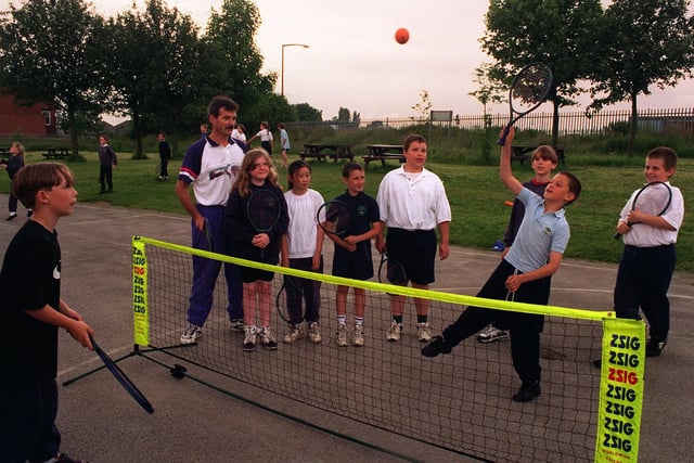Brian Wallwork, racket sports development officer for Leeds Leisure Services, is pictured coaching pupils at Manston Primary School. Pictured is Danny Driscoll (left) and Damian Lambert battling it out over the net.