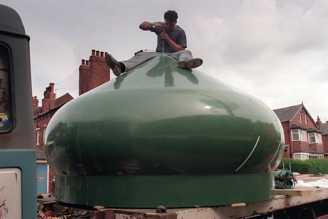 A construction worker prepares one of the two smaller domes for lifting into place on top of the new Bilal Mosque under construction in Harehills.